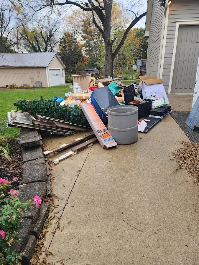Dumpster being loaded with debris for 12 Yard Dumpster Rental in Beardstown